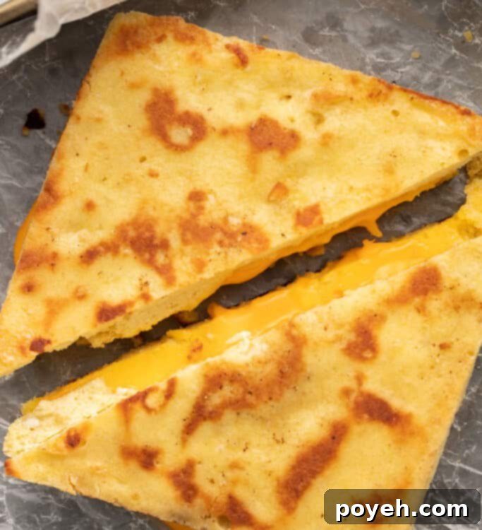 Keto grilled cheese sliced diagonally, showing the melted cheese and toasted bread