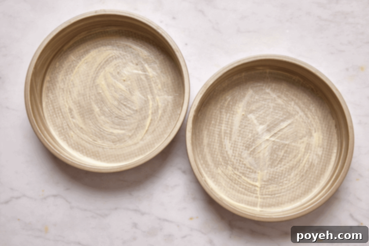 Two buttered and lined cake pans.