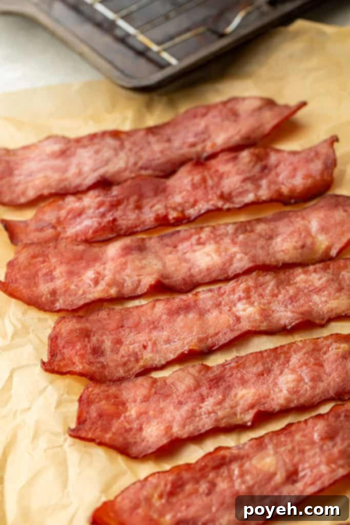 6 slices of turkey bacon laid diagonally across a sheet of parchment paper