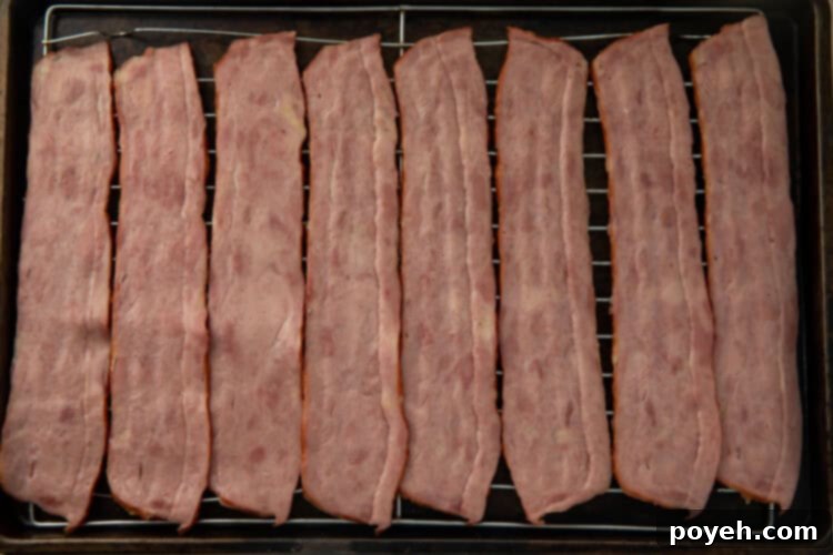Raw turkey bacon on a baking rack