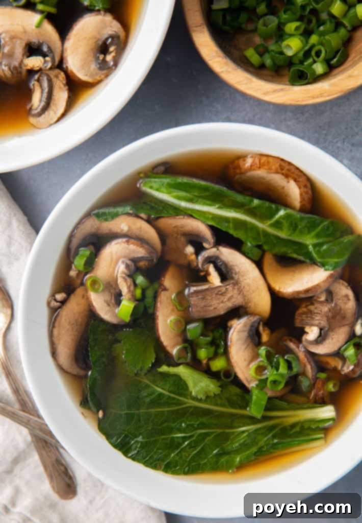 Overhead photo of a bowl of Chinese vegetable soup, garnished with fresh herbs.