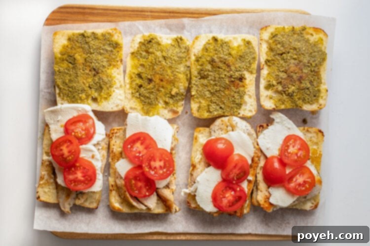 Tomato slices on top of mozzarella and chicken cutlets on ciabatta rolls.