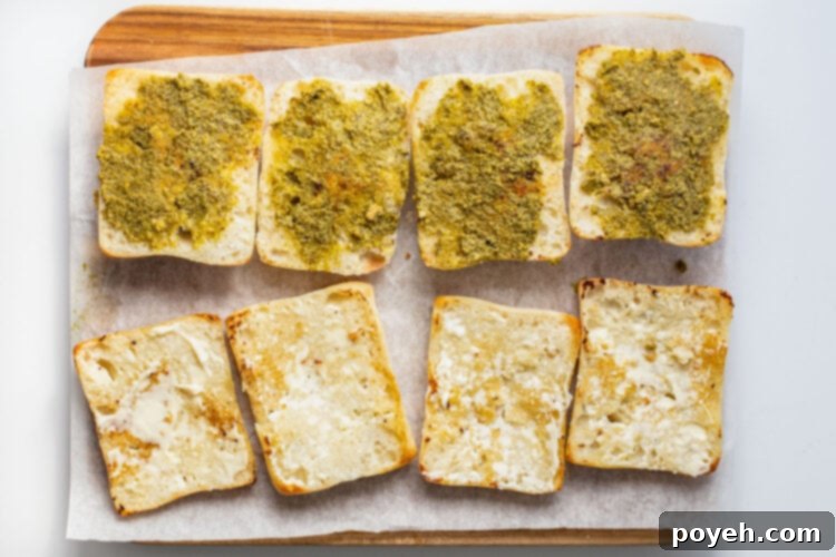 Ciabatta roll halves covered with pesto and mayo.