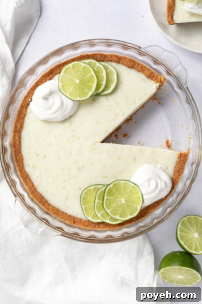 Step-by-step image showing the creamy Vegan Key Lime Pie filling being poured into a golden-brown graham cracker crust.