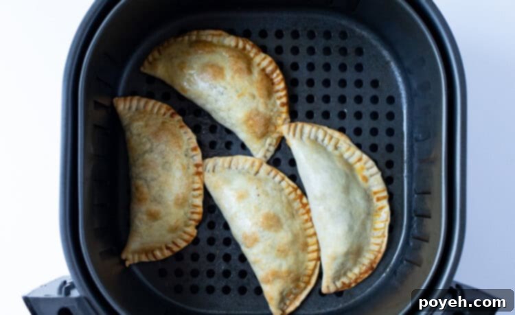 Air fryer empanadas in air fryer basket