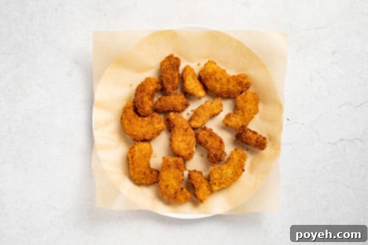 Frying vegan shrimp in a pan until golden brown and crispy