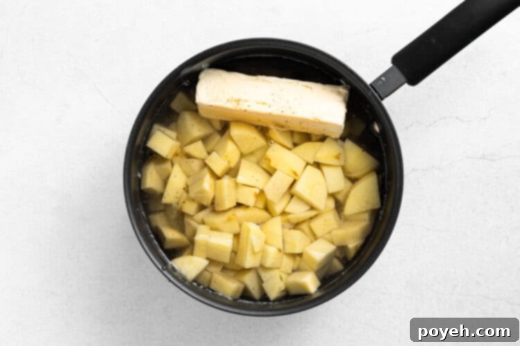 Step 1: Raw potatoes, butter, salt, and pepper in a pot, covered with water.