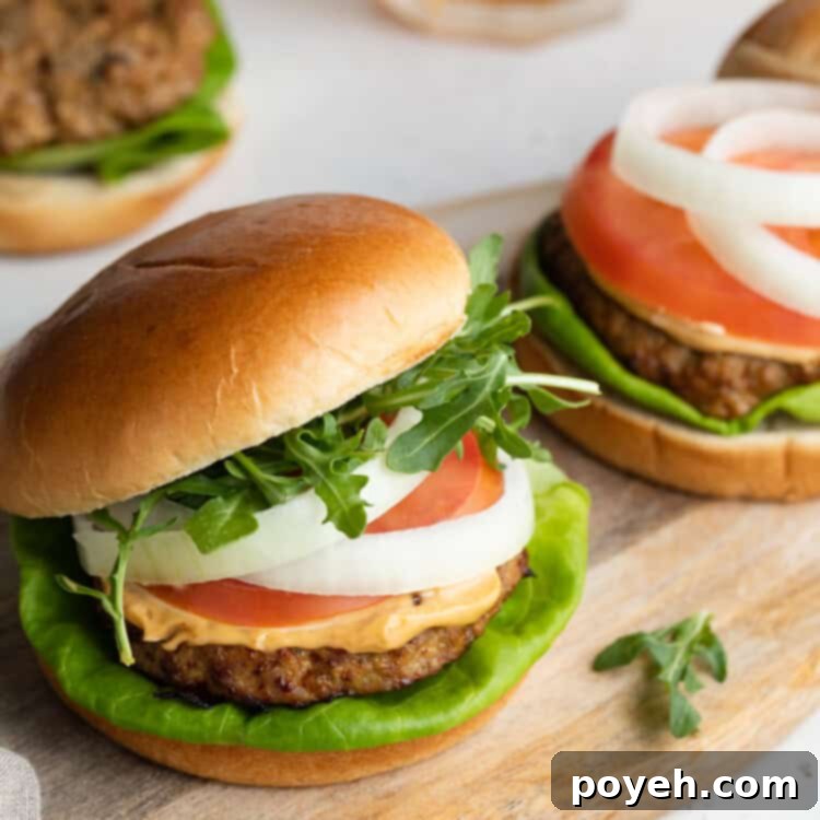 Three perfectly air-fried turkey burgers served alongside cold beer, showcasing a delicious and satisfying meal.