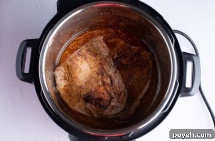 Flank steak submerged in marinade liquids inside an Instant Pot