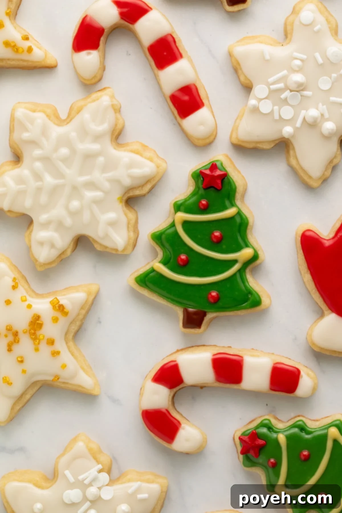 Close up of Christmas cookies with green, white, red, and yellow frosting.