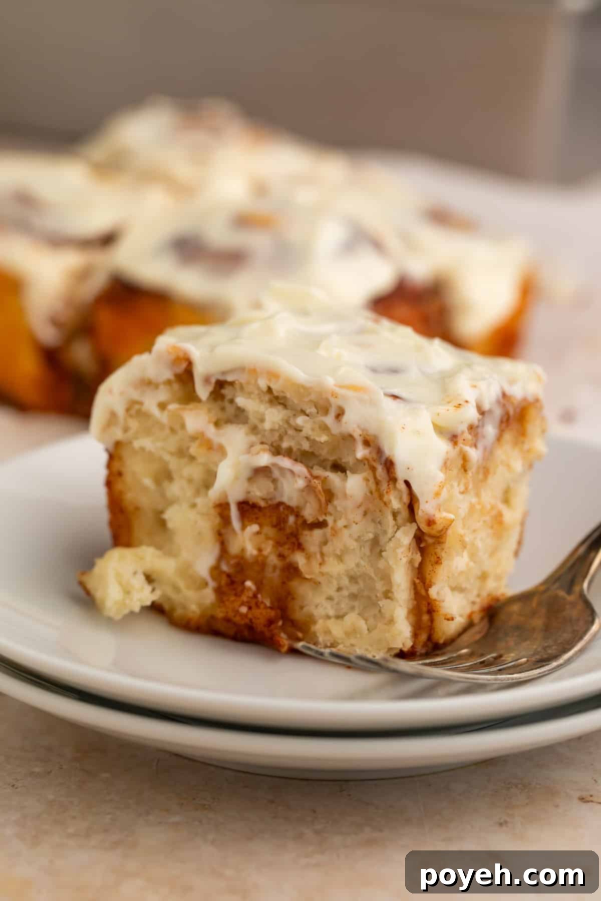 Freshly baked healthy cinnamon roll with cream cheese frosting