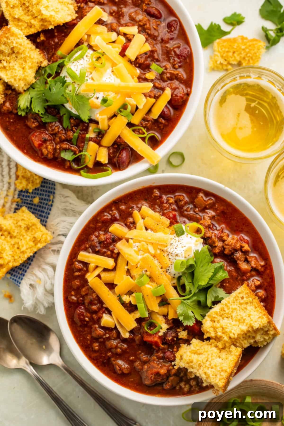Gluten-Free Chili Comfort 2 Bowls of gluten-free chili topped with cornbread, green onions, cheese, and sour cream
