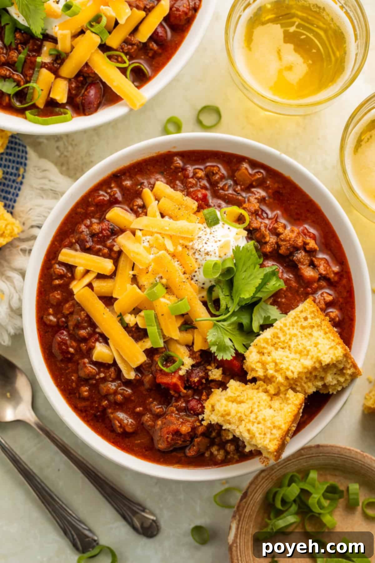 Gluten-Free Chili Comfort 3 Bowl of gluten-free chili with cornbread, green onions, sour cream, and shredded cheese
